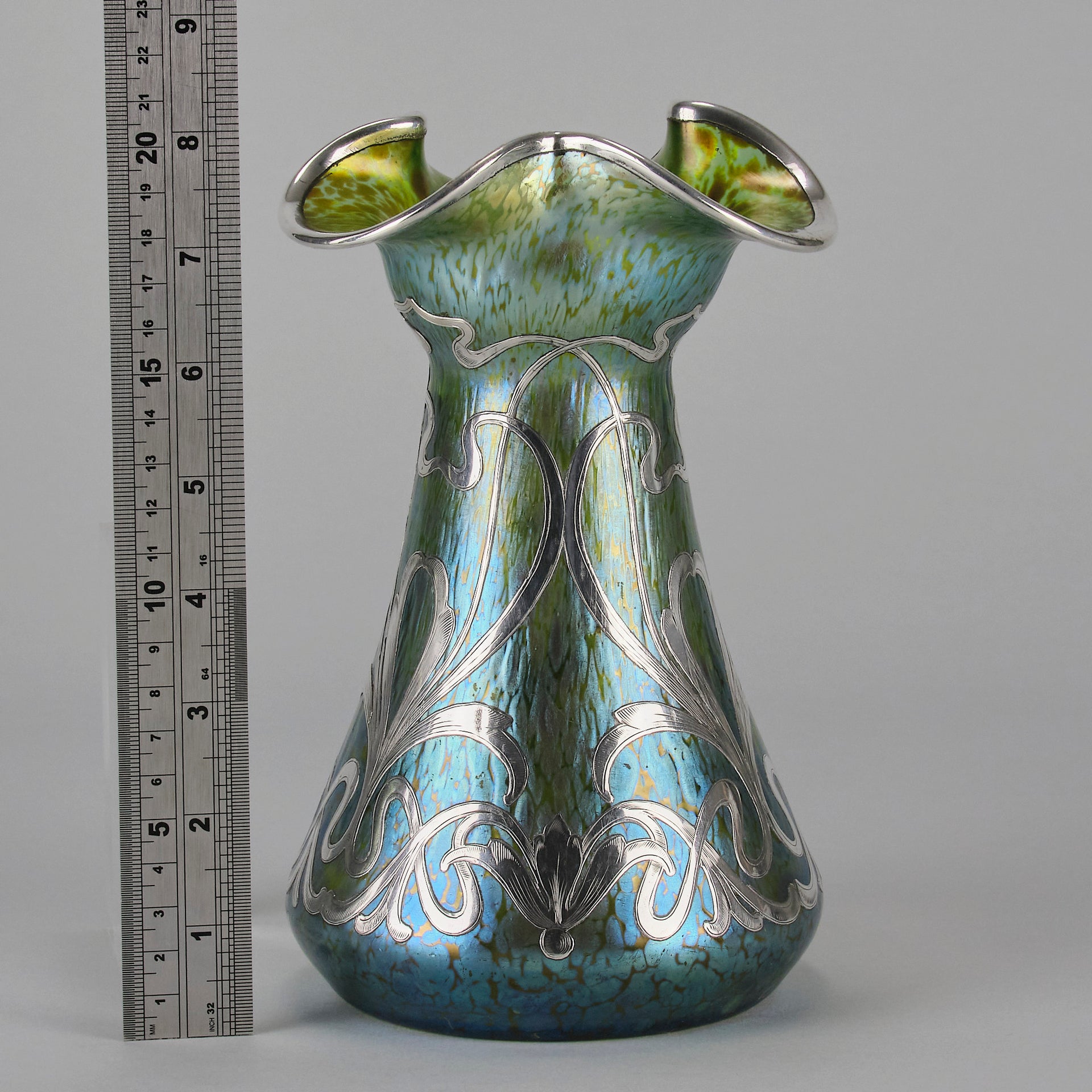 Silvered Papillon Vase by Loetz Witwe Art Nouveau tourquoise papillon glass vase, decorated with an applied silver floral organic pattern that wraps around the circumference of the body