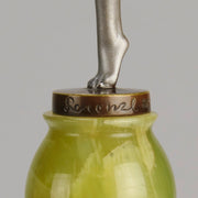 Art Deco Sculpture - Deco Dancer  by Josef Lorenzl  a cold painted bronze figure of a young woman holding a dancing pose with her hands lifted across her chest. The bronze figure with excellent colour and very fine hand chased surface detail, raised on a green onyx base  