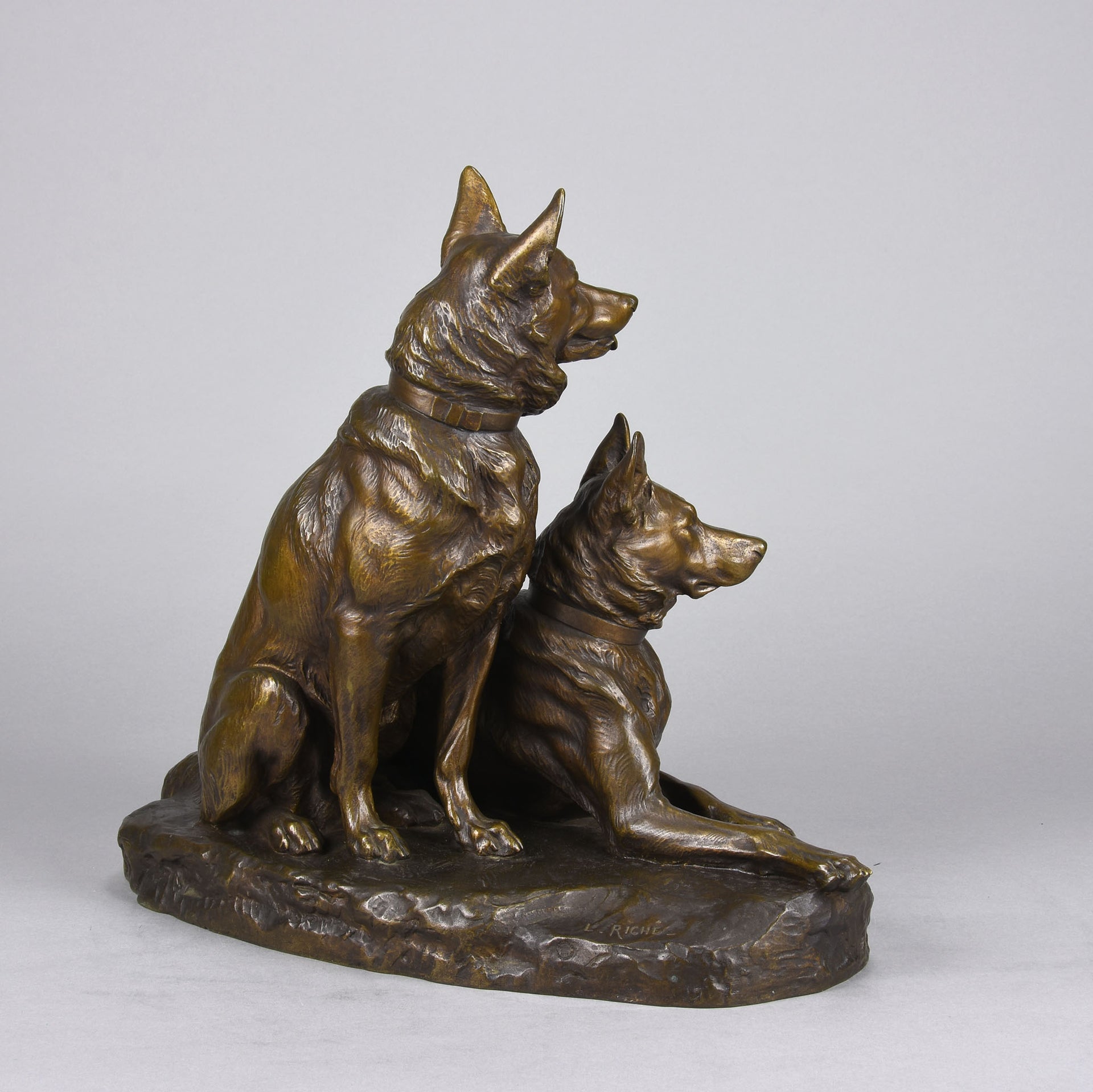 Two Alsatians by Louis Riché  gilt bronze group of two Alsatians, one seated in alert pose with its head turned slightly and ears pricked whilst the other one lays in an alert pose