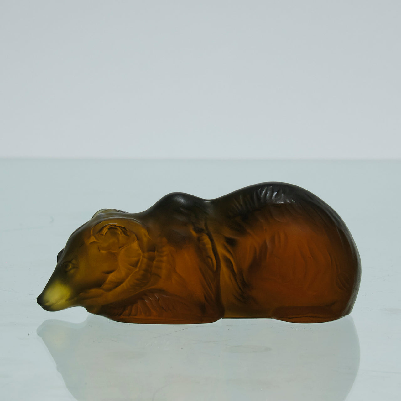 Ours Repose by Marc Lalique A sweet mid 20th Century frosted glass study of a resting bear, exhibiting excellent hand finished surface detail and rich deep amber colour