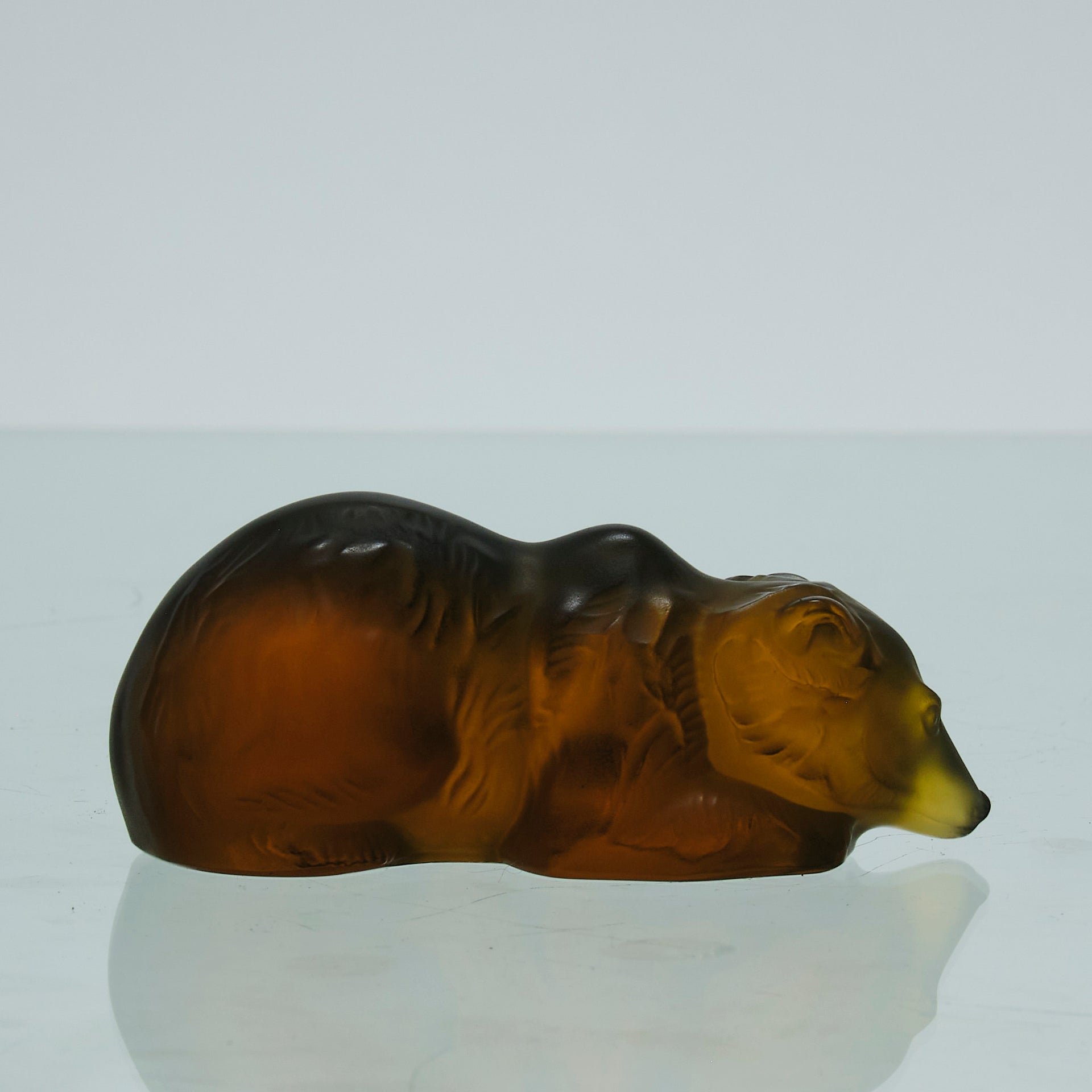 Ours Repose by Marc Lalique A sweet mid 20th Century frosted glass study of a resting bear, exhibiting excellent hand finished surface detail and rich deep amber colour