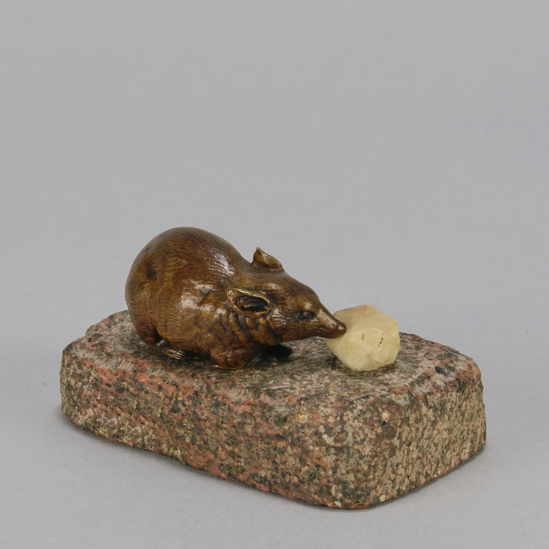 Antique Bronze Statue of a mouse nibbling some cheese depicted in cream marble. The bronze study exhibiting excellent hand chased surface detail and good colour, raised on a rough hewn granite base