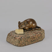 Antique Bronze Statue of a mouse nibbling some cheese depicted in cream marble. The bronze study exhibiting excellent hand chased surface detail and good colour, raised on a rough hewn granite base