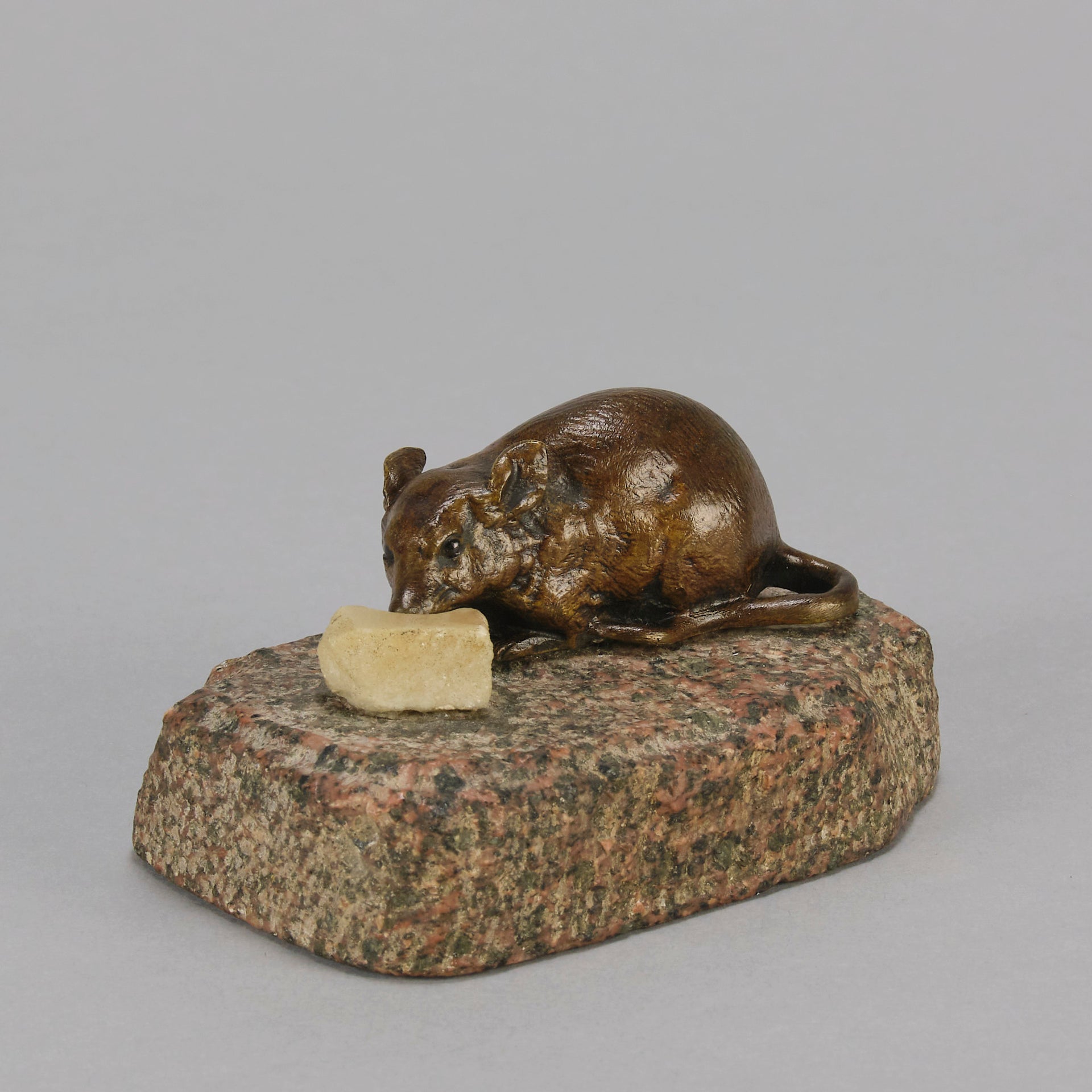 Antique Bronze Statue of a mouse nibbling some cheese depicted in cream marble. The bronze study exhibiting excellent hand chased surface detail and good colour, raised on a rough hewn granite base