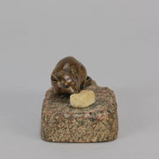 Antique Bronze Statue of a mouse nibbling some cheese depicted in cream marble. The bronze study exhibiting excellent hand chased surface detail and good colour, raised on a rough hewn granite base