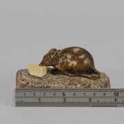 Antique Bronze Statue of a mouse nibbling some cheese depicted in cream marble. The bronze study exhibiting excellent hand chased surface detail and good colour, raised on a rough hewn granite base
