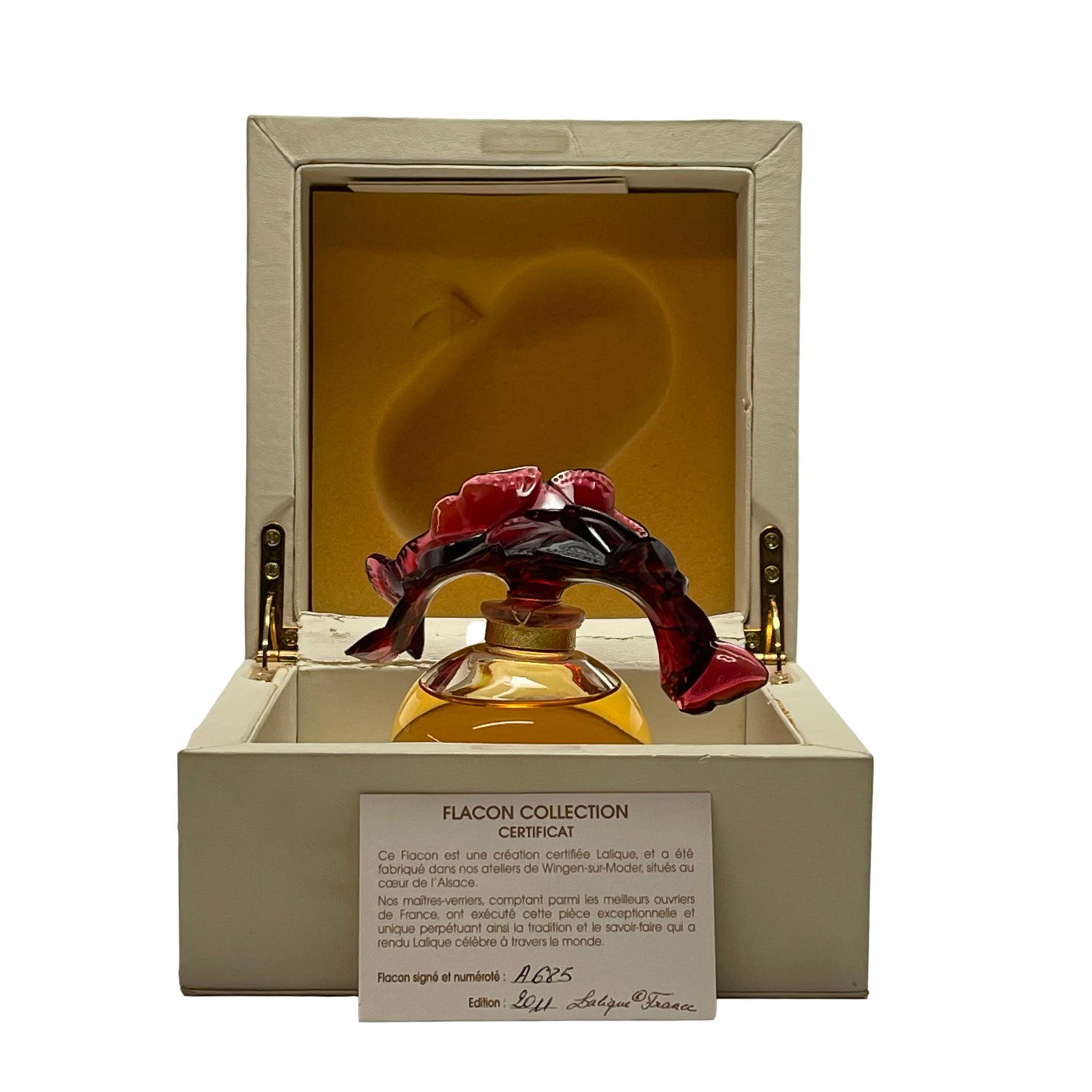 Envol Perfume Bottle by Marie Claude Lalique A stunning limited edition clear and coloured glass scent bottle, the clear glass body containing the original Lalique perfume complete with a deep red glass stopper in the form of entwined butterflies - Hickmet Fine Arts