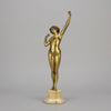 Art Deco Sculpture Le Reveil by Paul Philippe painted gilt and enamel bronze a attractive young woman as she stretches in the morning, raised on a shaped marble base