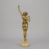 Art Deco Sculpture Le Reveil by Paul Philippe painted gilt and enamel bronze a attractive young woman as she stretches in the morning, raised on a shaped marble base