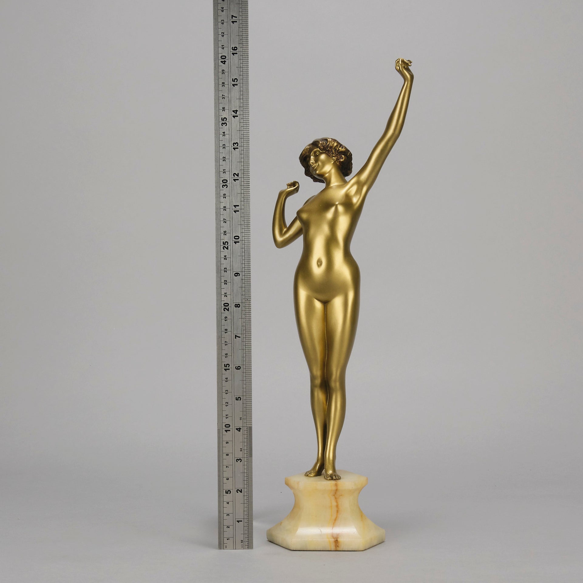 Art Deco Sculpture Le Reveil by Paul Philippe painted gilt and enamel bronze a attractive young woman as she stretches in the morning, raised on a shaped marble base