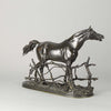 Djinn - Etalon Barbe by Antoine louis barye an antique bronze study of a stallion standing behind a post and rail fence