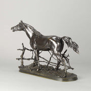 Djinn - Etalon Barbe by Antoine louis barye an antique bronze study of a stallion standing behind a post and rail fence