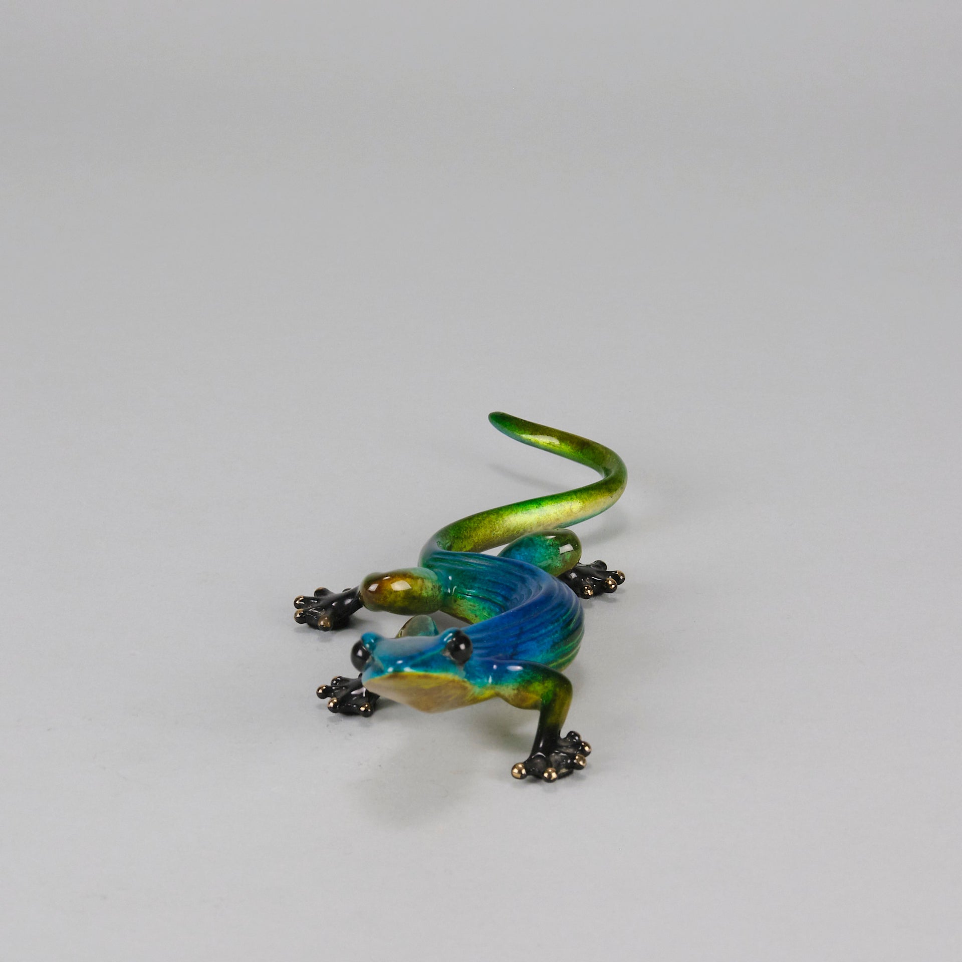 Margarita Gecko by Tim Cotterill a bronze study of a gecko with its head raised exhibiting very fine vibrant colours and excellent surface detail