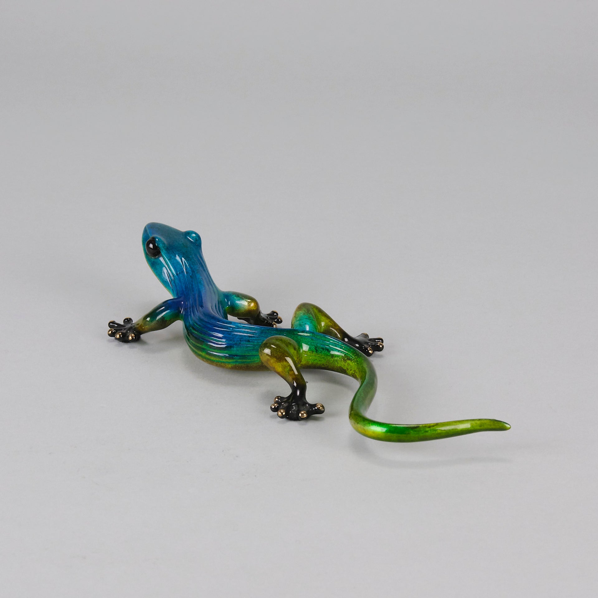 Margarita Gecko by Tim Cotterill a bronze study of a gecko with its head raised exhibiting very fine vibrant colours and excellent surface detail