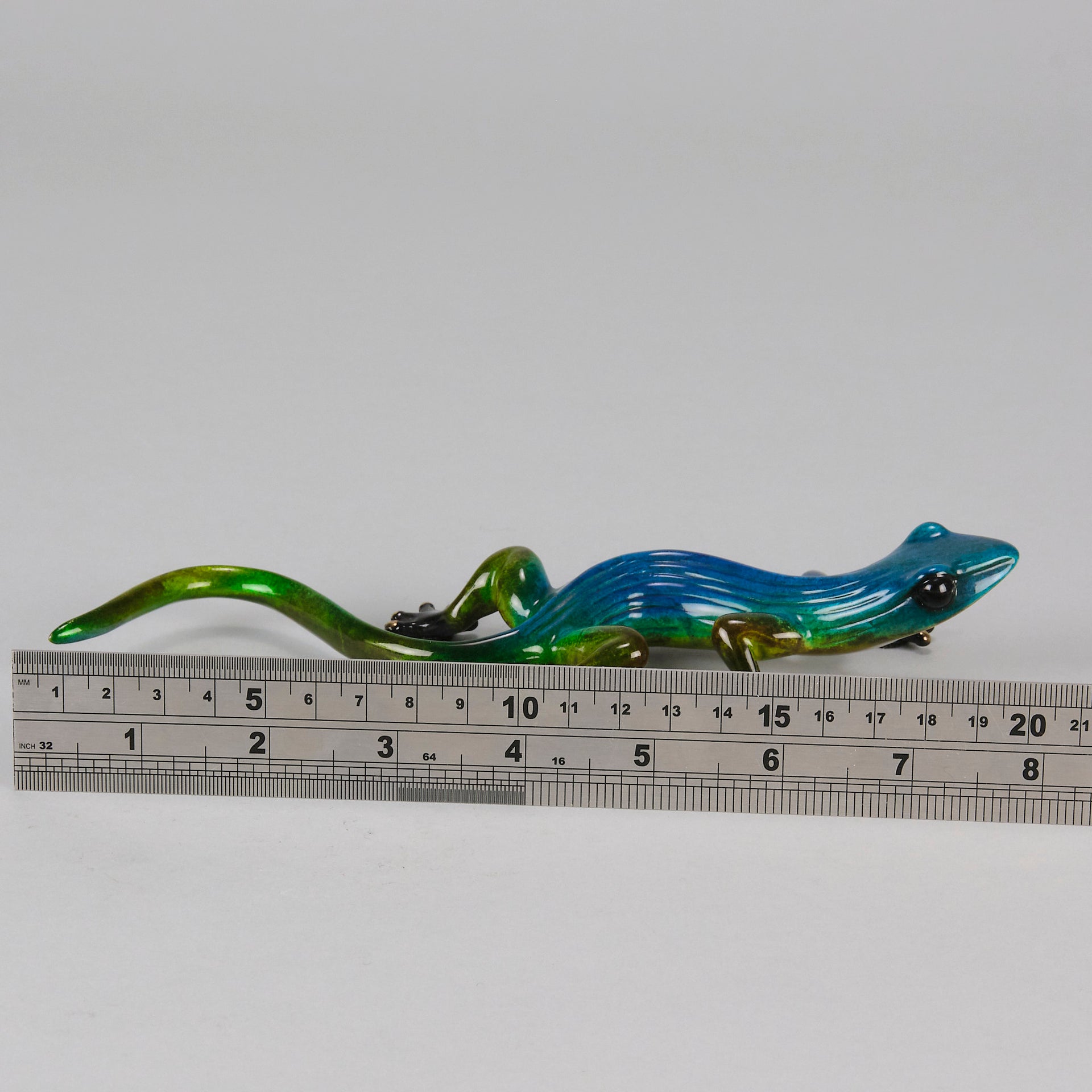 Margarita Gecko by Tim Cotterill a bronze study of a gecko with its head raised exhibiting very fine vibrant colours and excellent surface detail