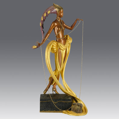 Pleasures of the Courtesan by Erté an attractive limited edition 20th Century bronze figure modelled as a beautiful young woman holding a long golden chain from a treasure chest at her feet wearing only an flamboyant skirt & headdress