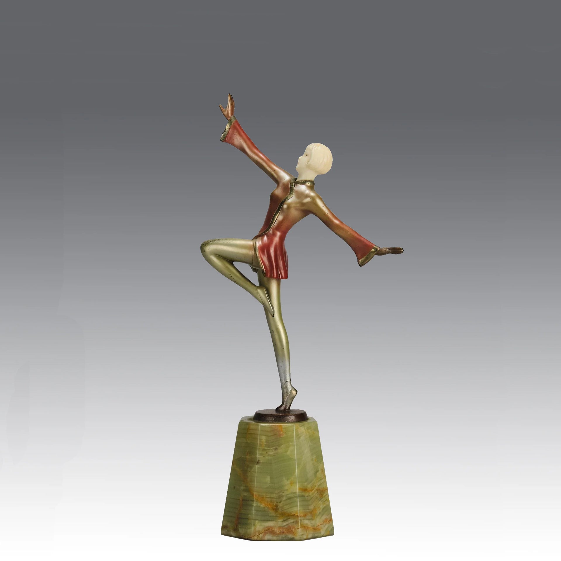 Helga by Josef Lorenzl An Art Deco Bronze and ivory igure of a beautiful dancer holding an elegant pose exhibiting excellent colour and very fine hand chased surface detail, raised on a green onyx base 