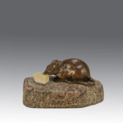 Antique Bronze Statue of a mouse nibbling some cheese depicted in cream marble. The bronze study exhibiting excellent hand chased surface detail and good colour, raised on a rough hewn granite base