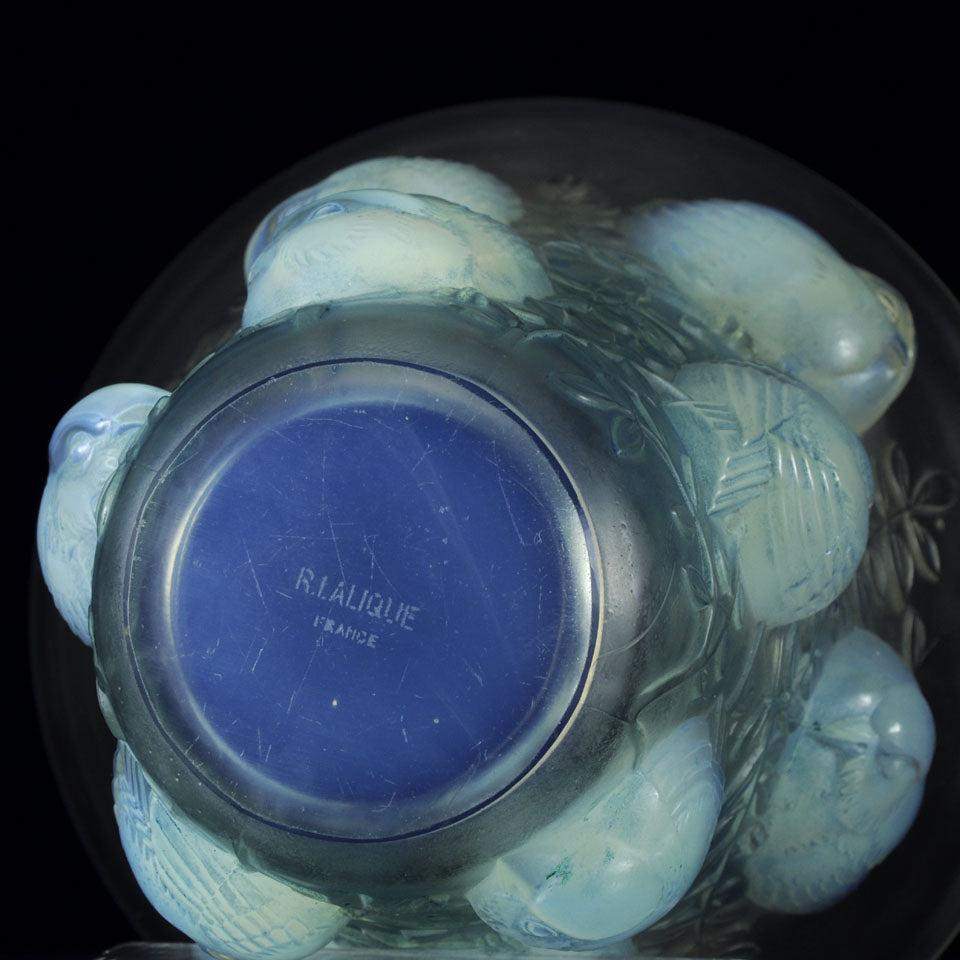 Saint Francois by Rene Lalique an impressive frosted glass vase with flared rim on tapering cylindrical body of opalescent glass, relief-decorated with birds, leaves, and vines with excellent colour